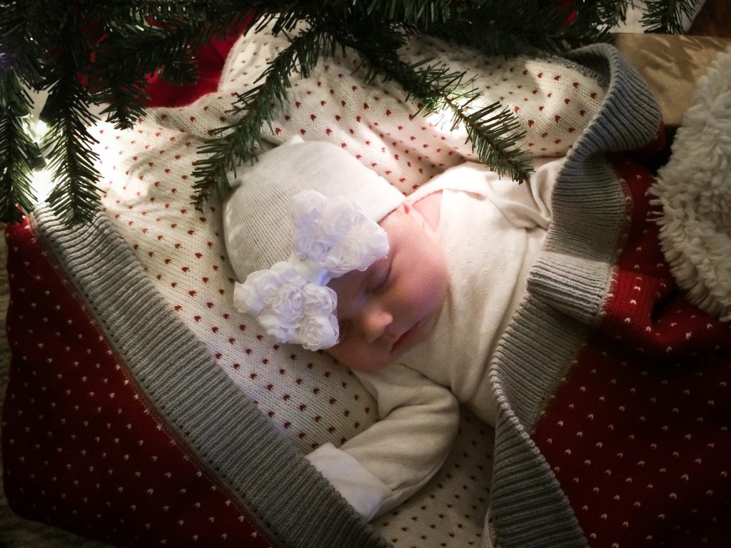 Baby under Christmas tree 
